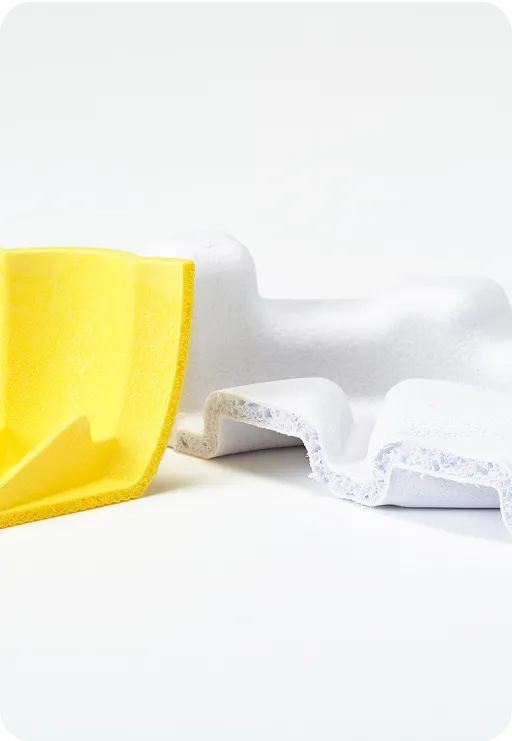 Close-up of yellow and white molded fiber packaging pieces showing eco-friendly, biodegradable material with textured layers for protective design.