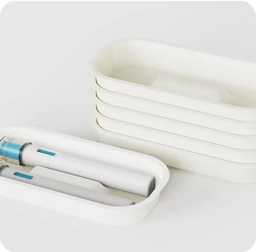 Stacked biodegradable molded fiber trays with pen-shaped medical devices, sustainable and plastic-free medical packaging solution.