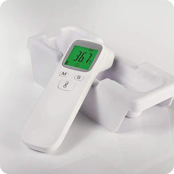 Digital thermometer in molded fiber protective packaging, highlighting sustainable and biodegradable design for medical device protection.