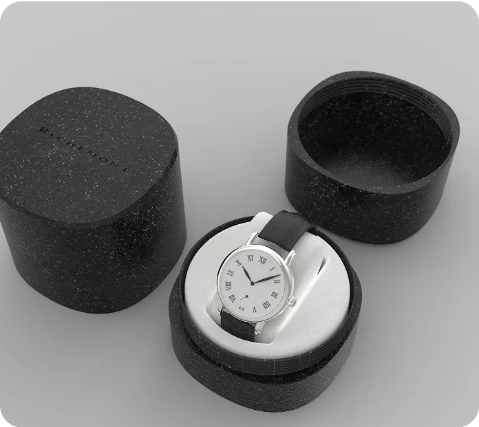 Luxury wristwatch with black leather strap in a black eco-friendly circular watch box, showcasing sustainable premium packaging design.