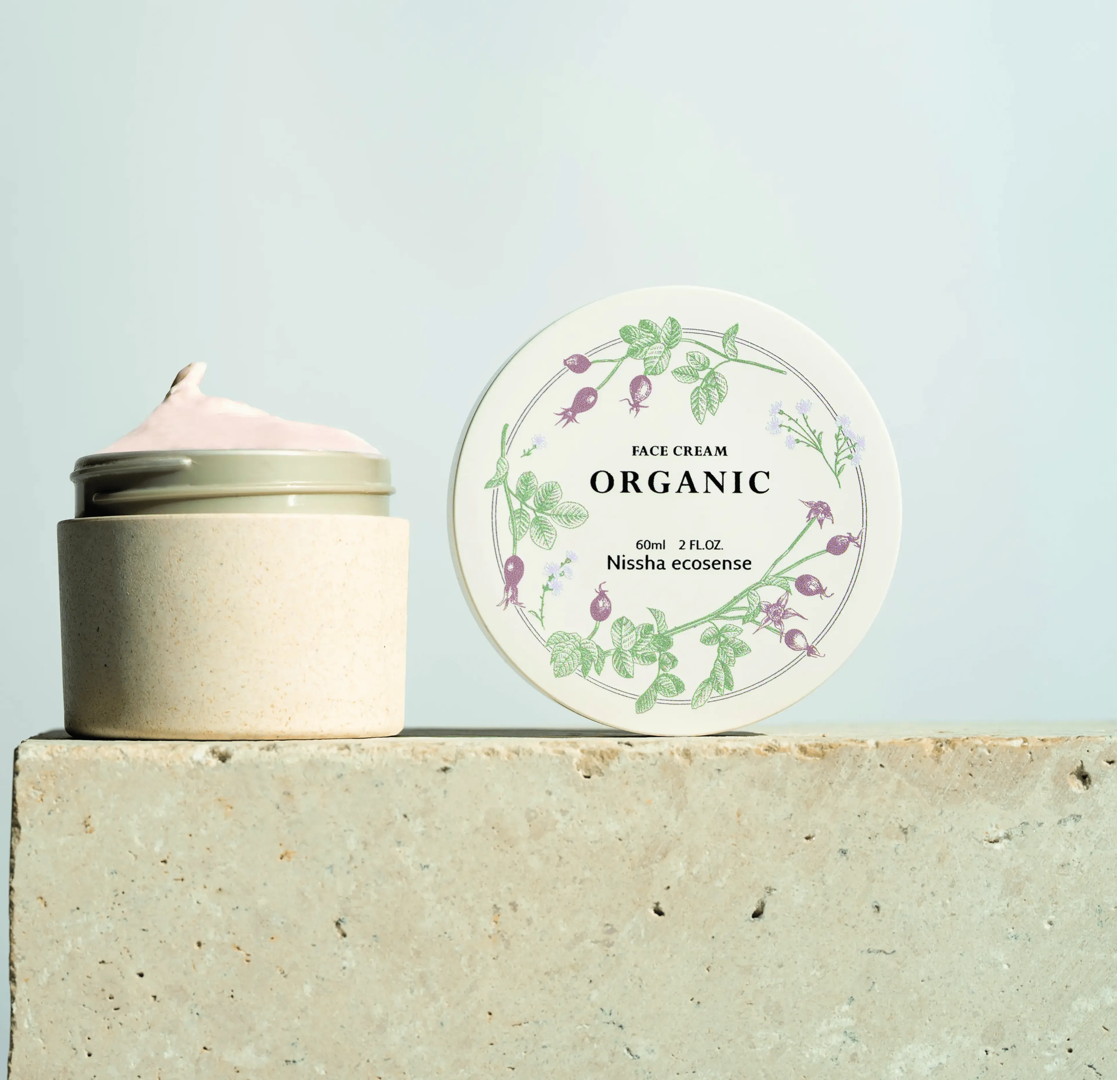 Eco-friendly organic face cream jar with botanical design and sustainable beige packaging, labeled Nissha ecosense, promoting natural skincare and sustainability.