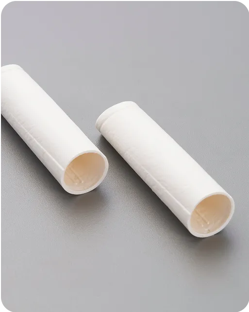 Eco-friendly molded fiber tubes on gray surface, showcasing sustainable paper-based packaging components for medical or cosmetic applications.