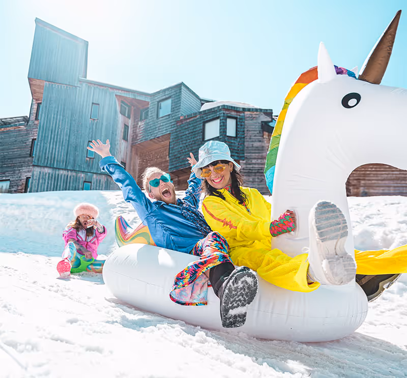 People having fun on an inflatable unicorn