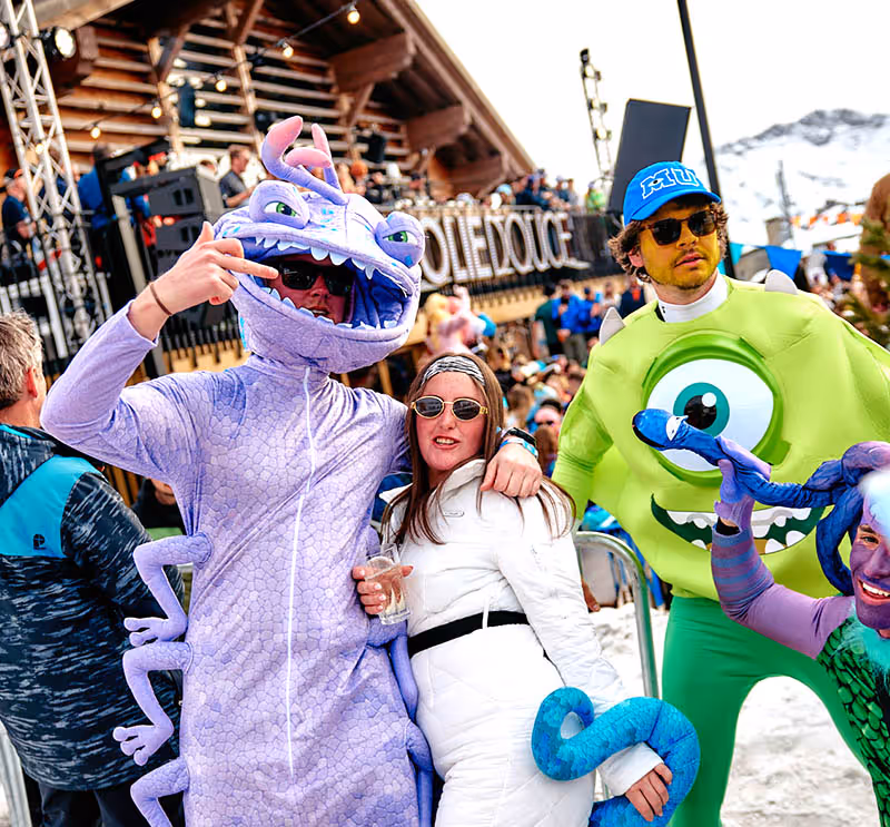 People dressed as characters from Monsters Inc at Apres on the mountainside