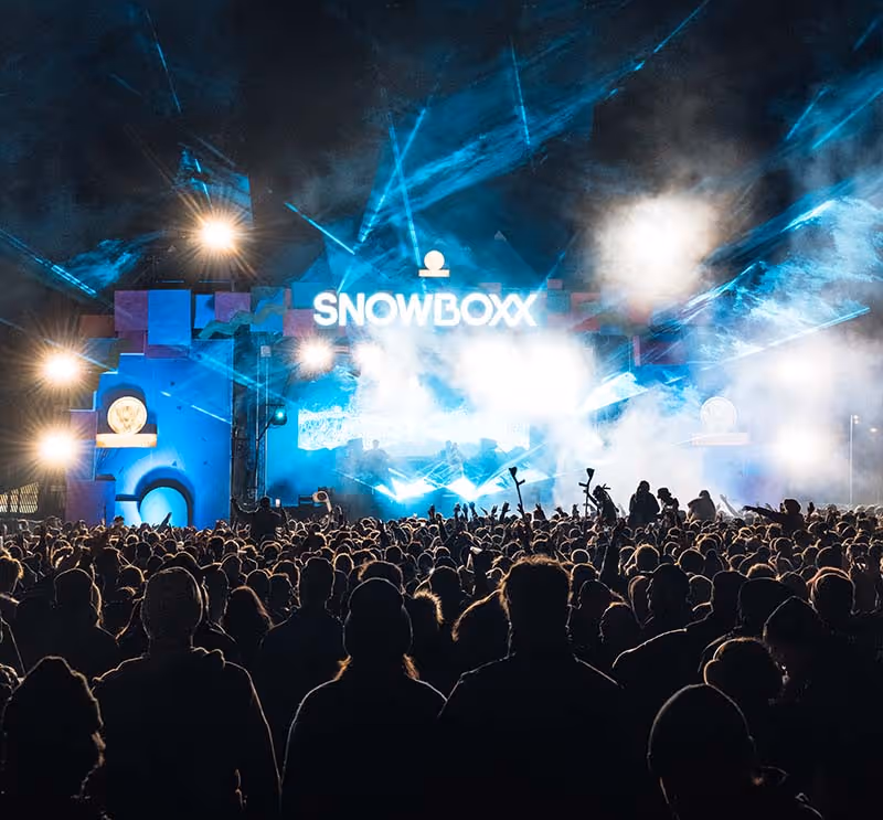 Snowboxx main stage at night, huge crowd in amongst the smoke and lights
