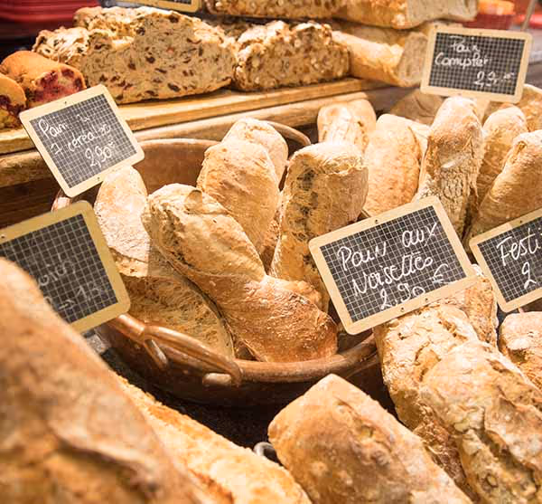Freshly baked baguettes on display in a deli counter