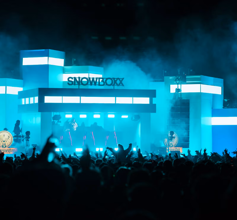 Snowboxx main stage at night, huge crowd in amongst the smoke and lights