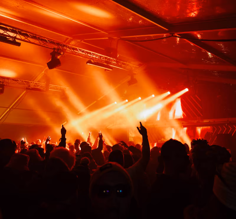 The Boxx stage at Snowboxx, a big crowd gathers as the stage is illuminated in red