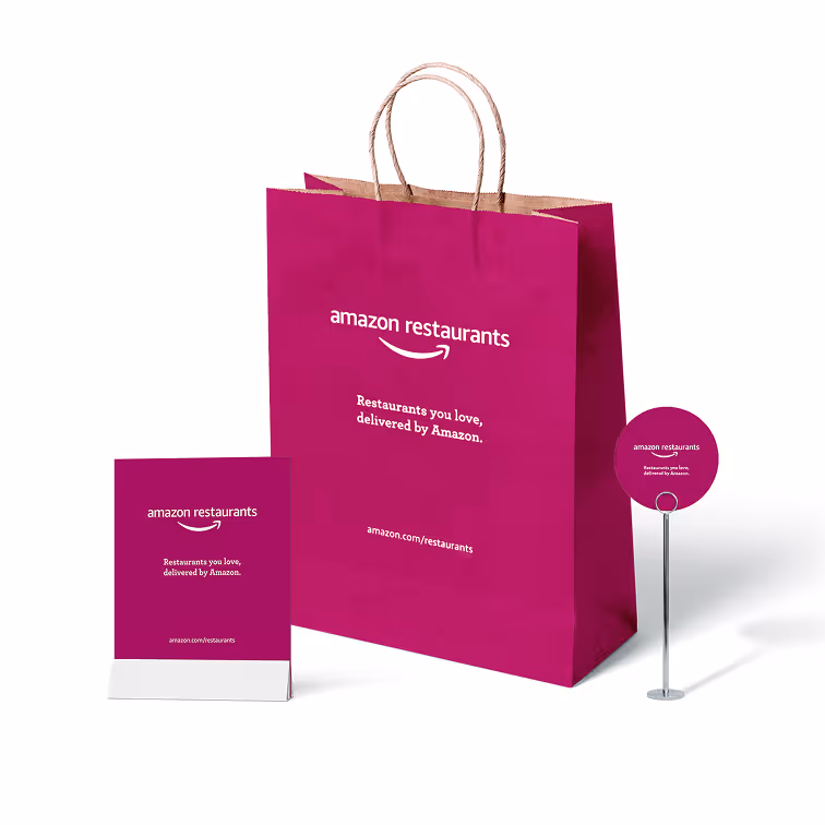 Branded packaging set including shopping bag, takeout box, and promotional sign.