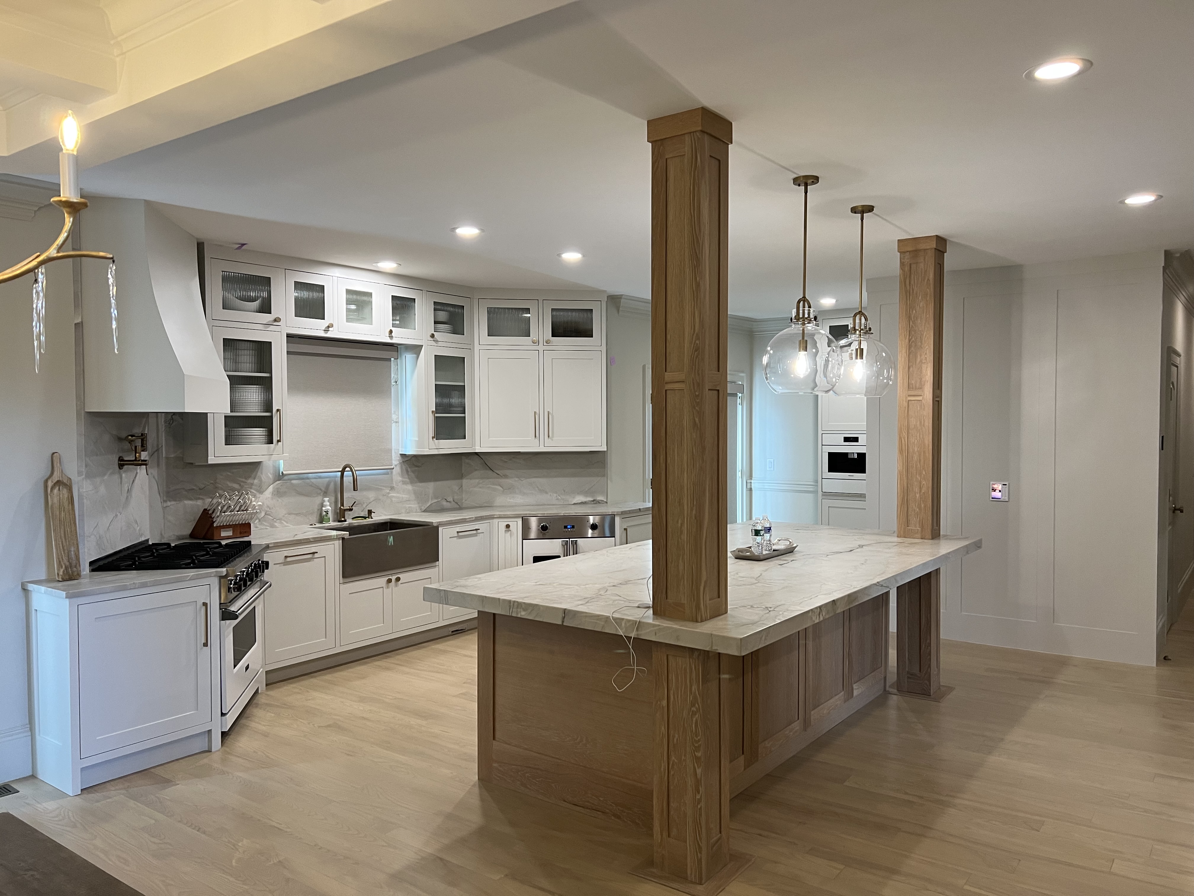White custom kitchen cabinets with brass hardware, range and refrigerator in Asheville NC