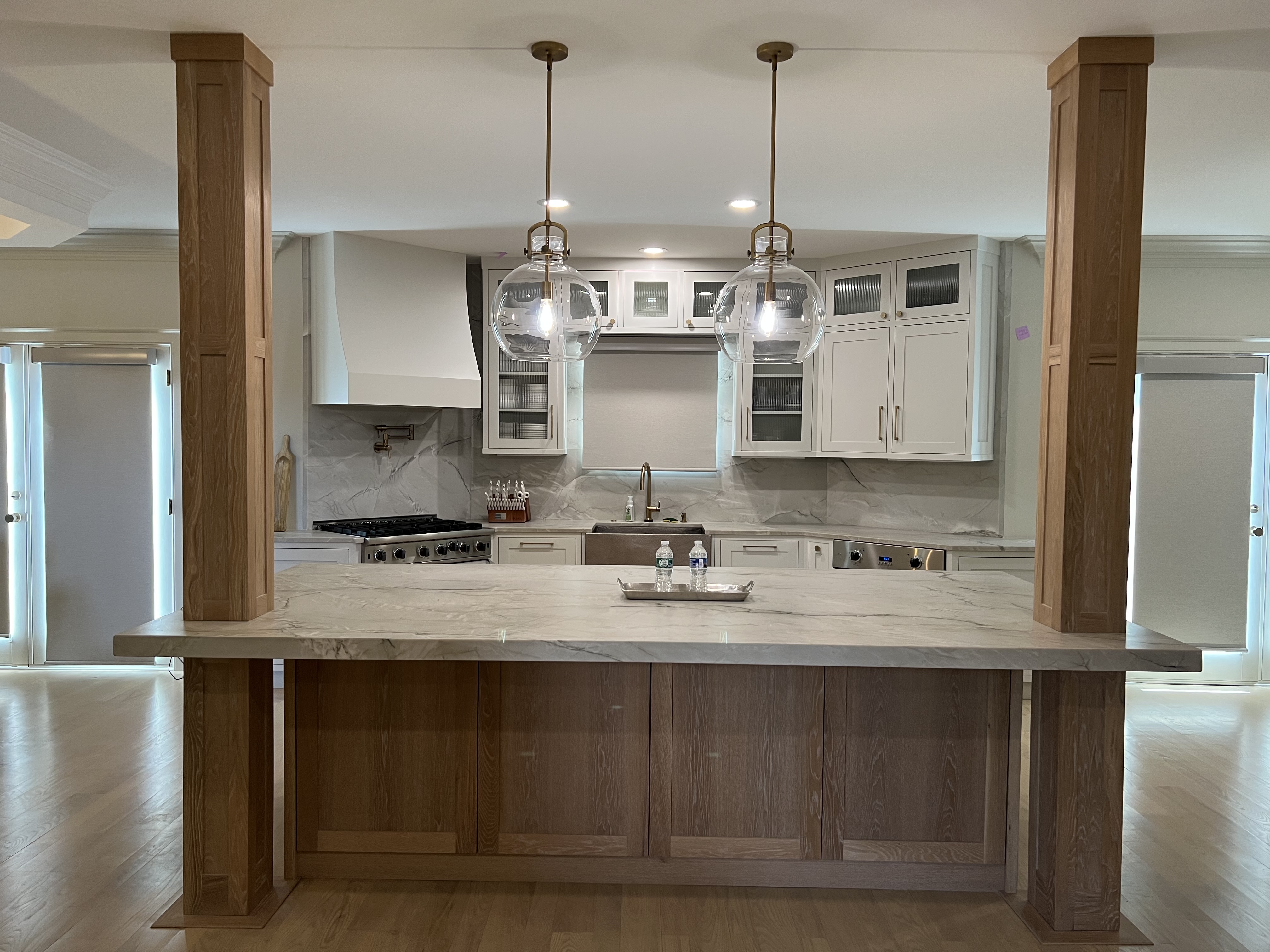 White custom kitchen cabinets with brass hardware, range and refrigerator in Asheville NC