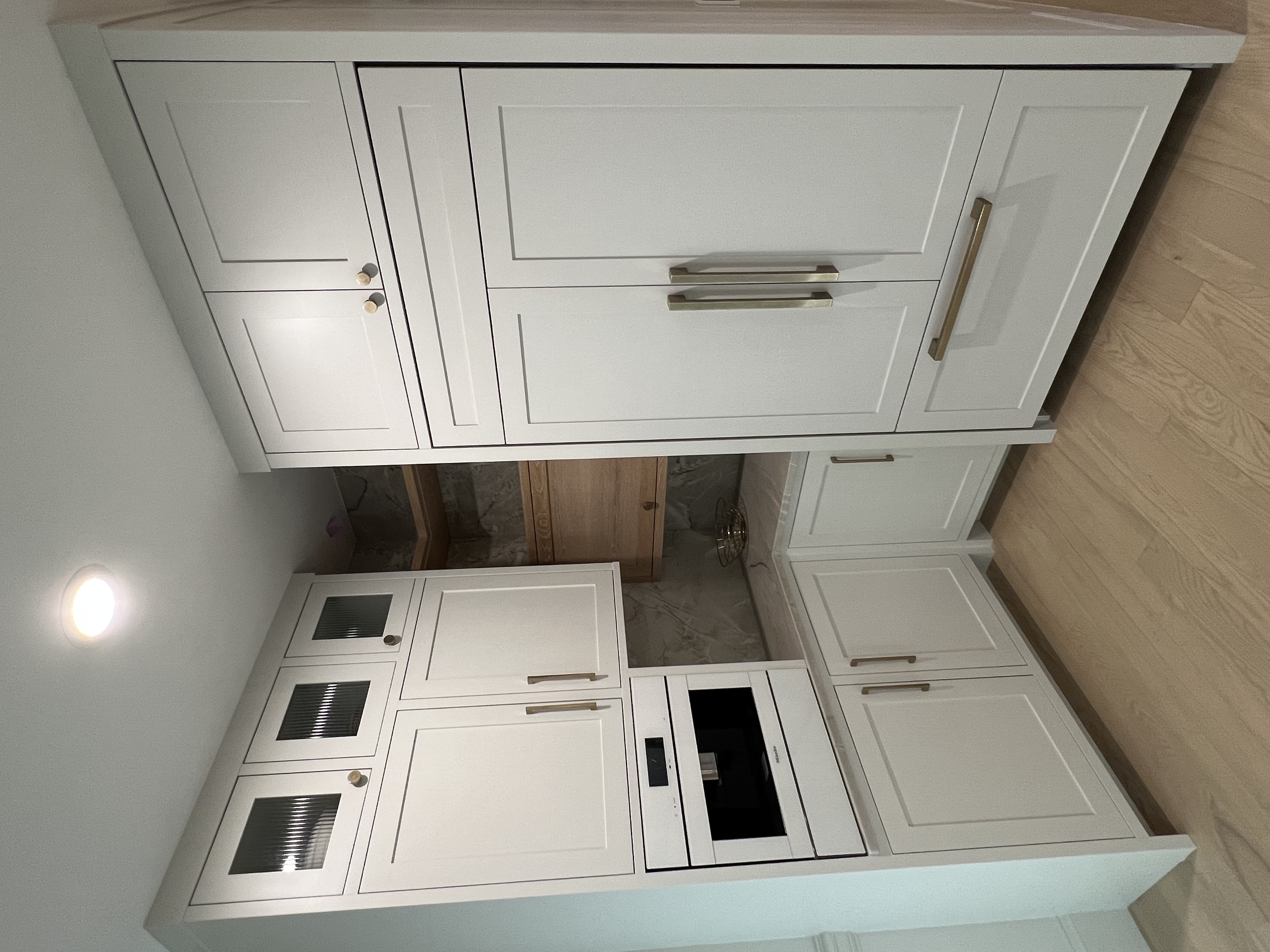 White custom kitchen cabinets with built-in oven and refrigerator in Asheville NC