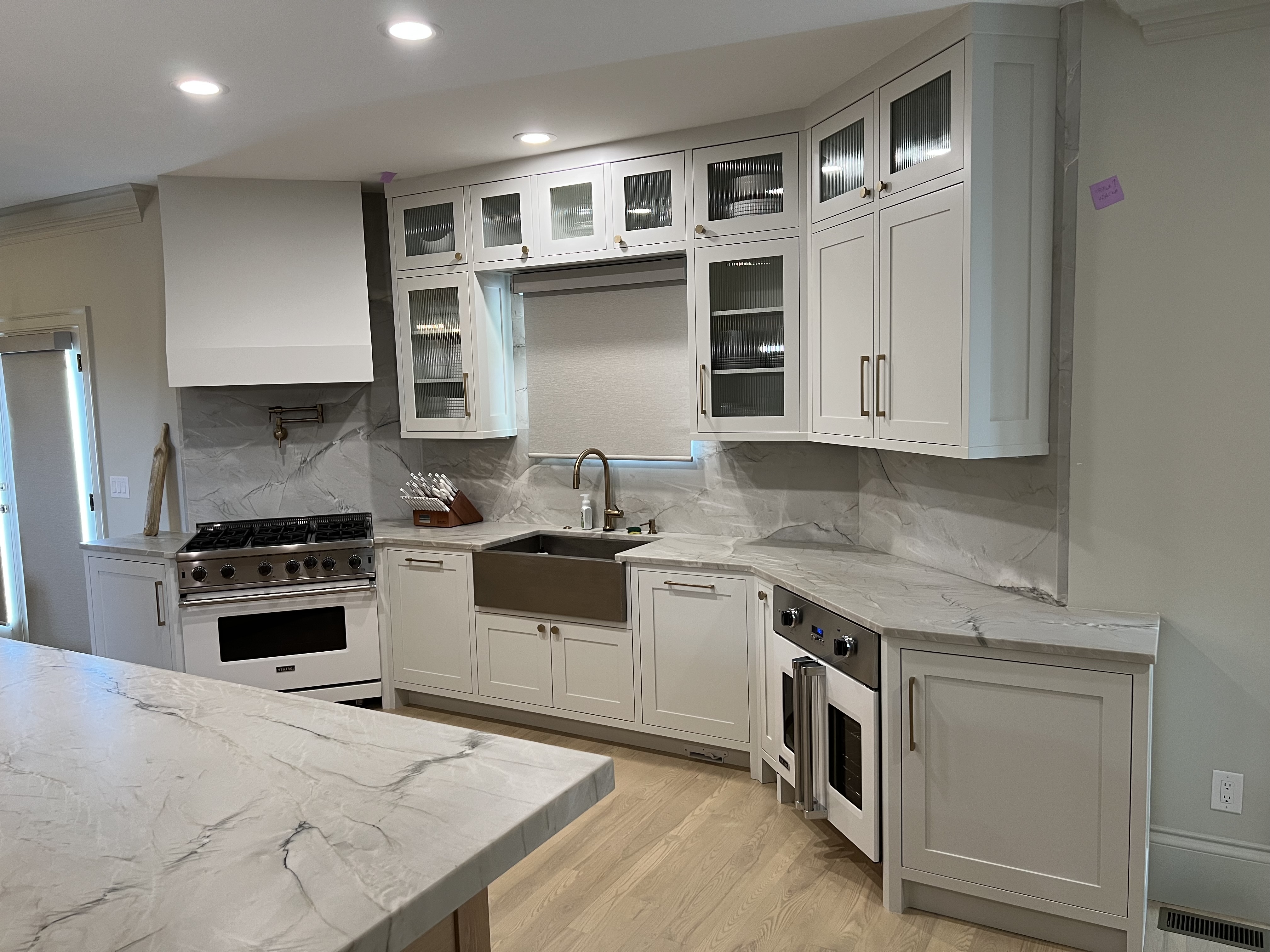 White custom kitchen cabinets with built-in oven and refrigerator in Asheville NC