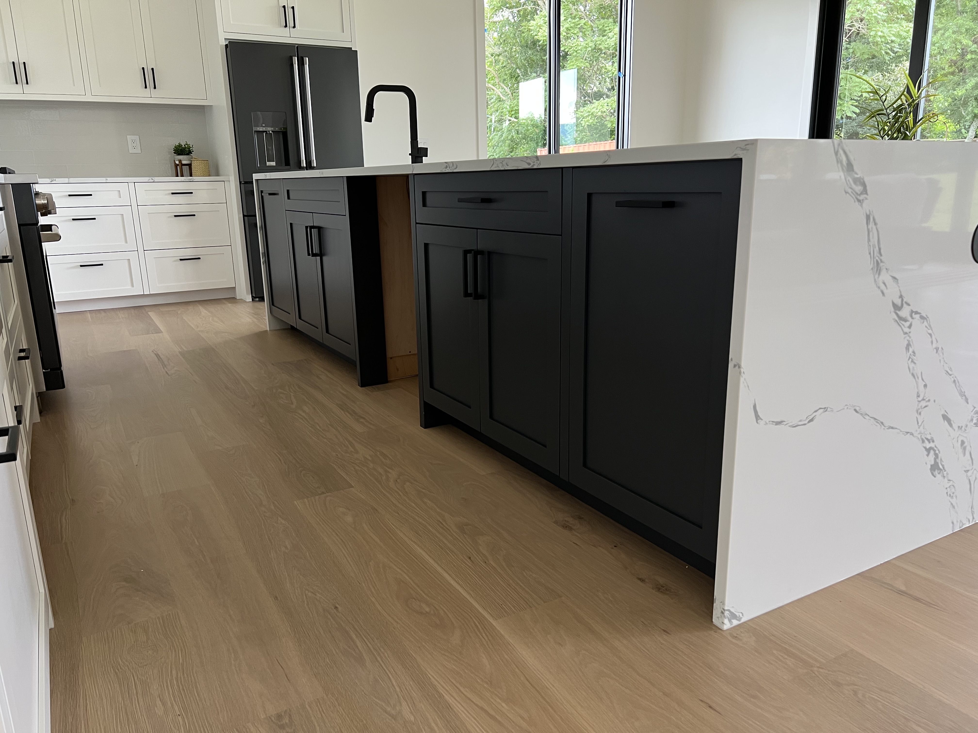 Custom kitchen island with white cabinetry and wood flooring in Asheville NC