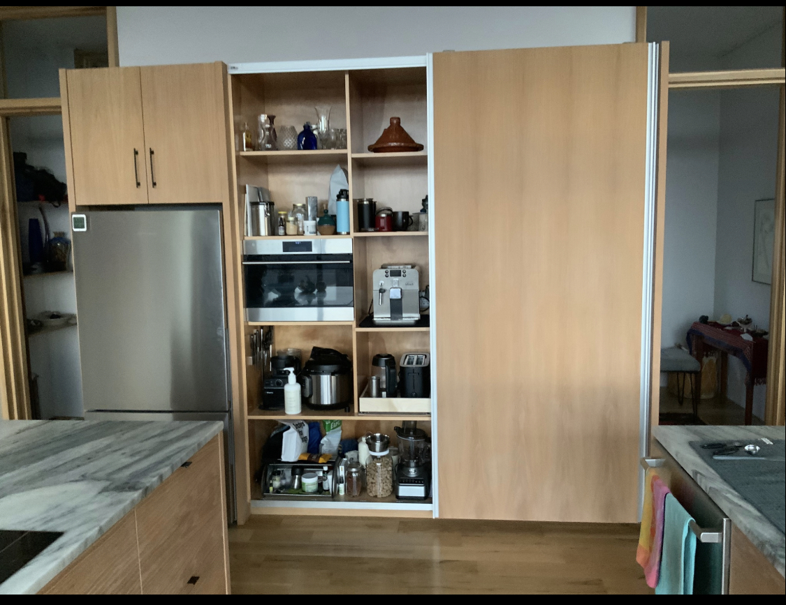 Custom kitchen island with white cabinetry and wood flooring in Asheville NC