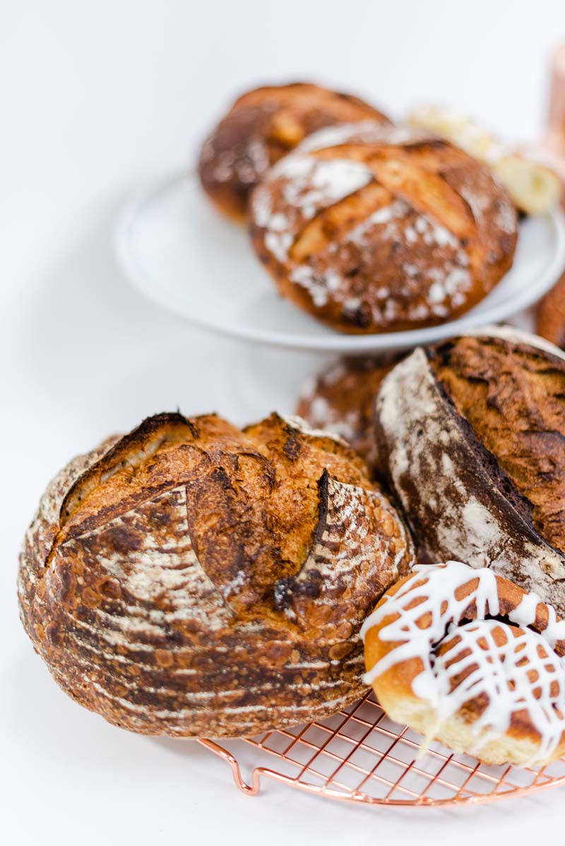 A plate of bread with white icing on top.