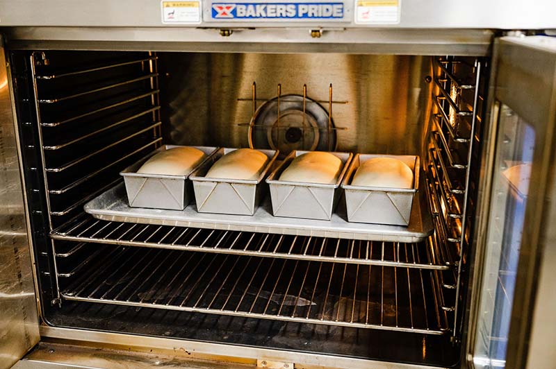 A baker's pride oven with bread in it.