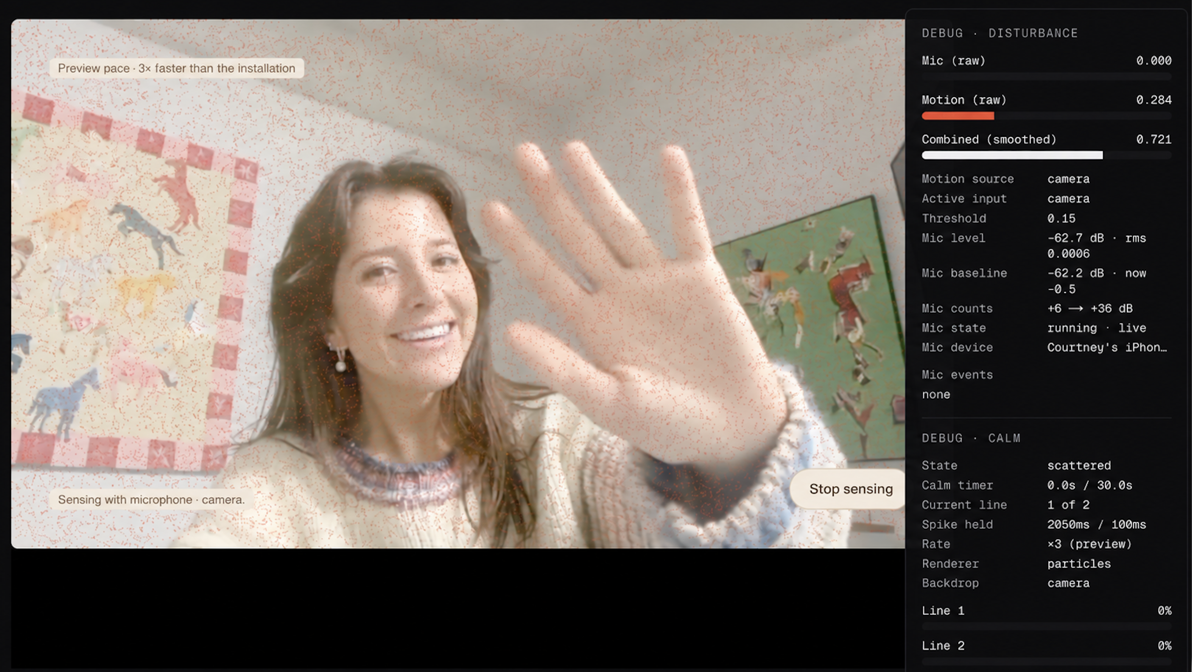 Smiling woman in a light sweater waving with her hand close to the camera, with two colorful animal posters on the wall behind her and a dark overlay panel on the right displaying debug information about microphone and motion sensing.