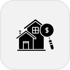 Icon showing two houses with a magnifying glass featuring a dollar sign.