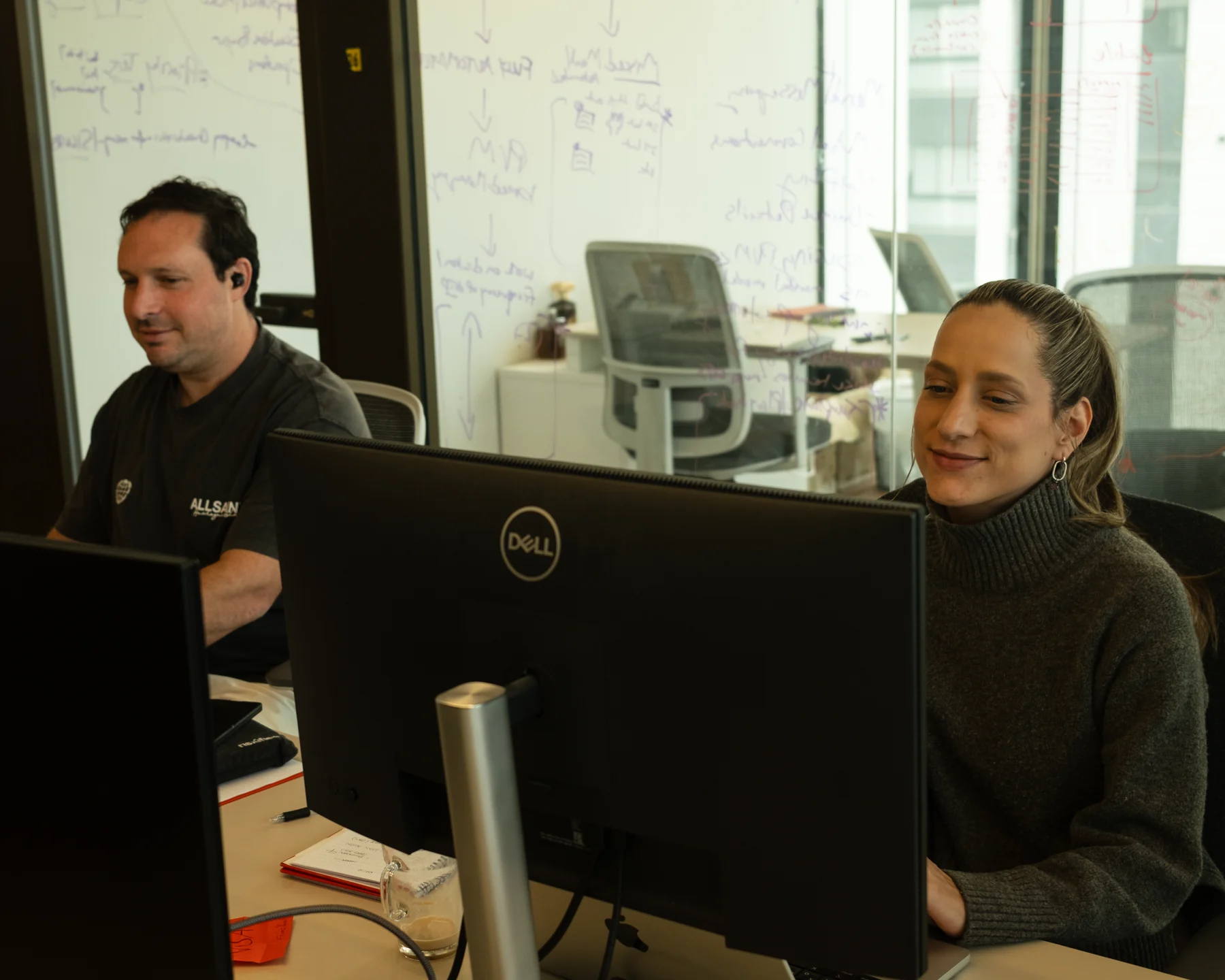 Two Ballerine team members at their desks in the Tel Aviv office