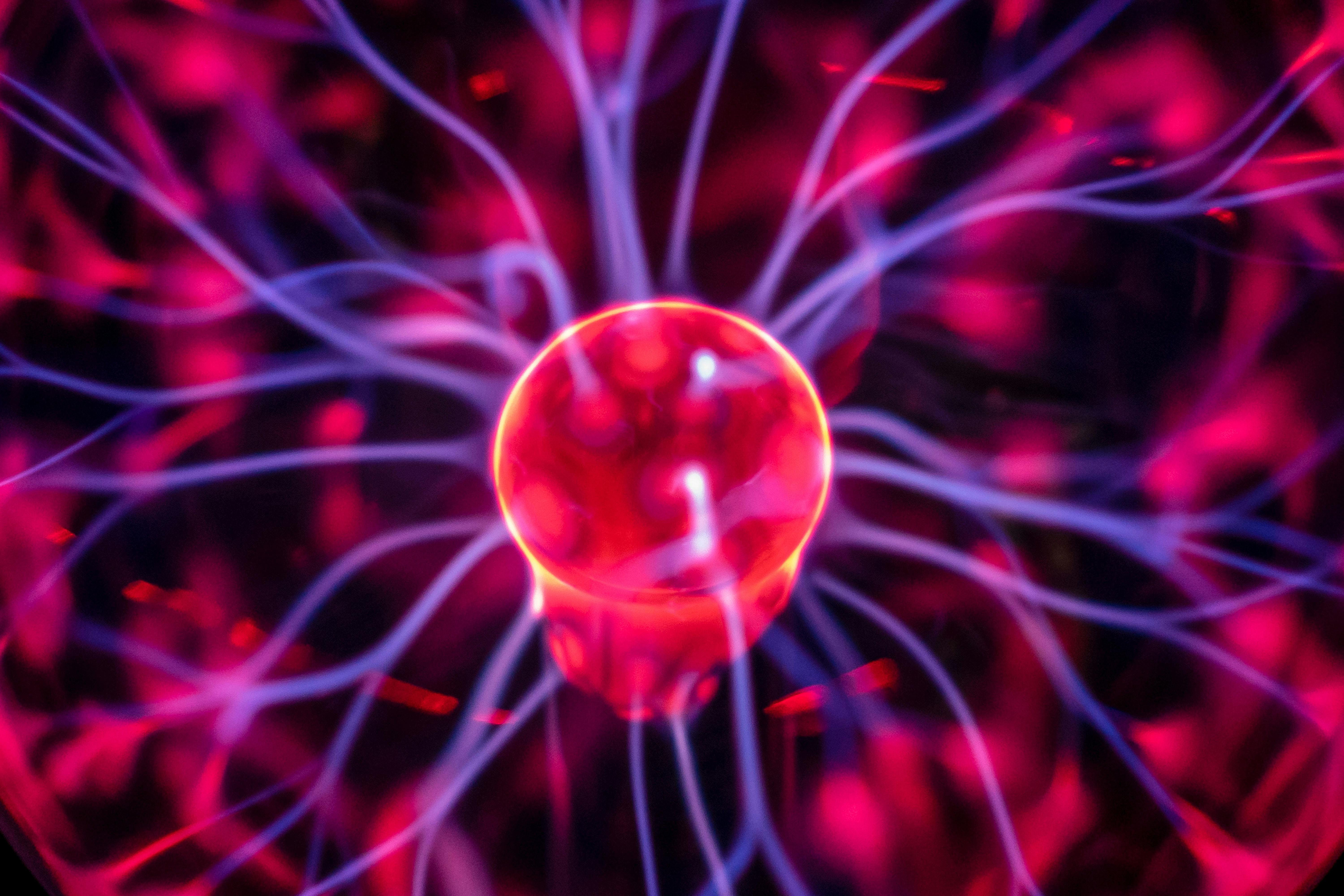 Close-up of a glowing plasma globe with electric currents, symbolizing technology, innovation, and the power of AI.