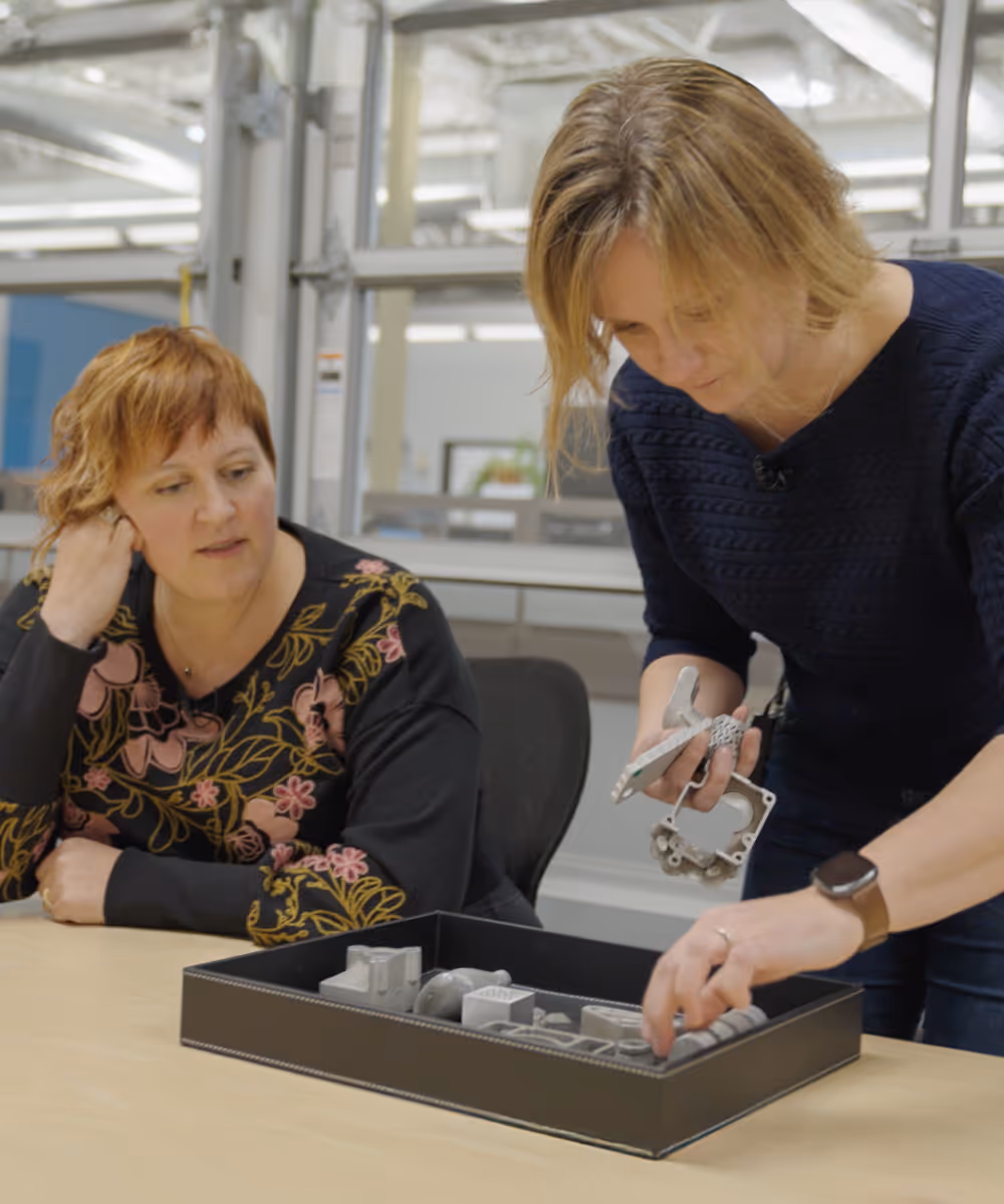 A client demonstrating some of their manufactured materials to Danielle.