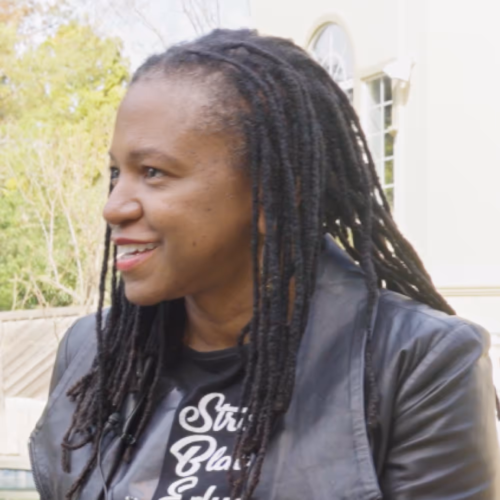 A female CEO being interviewed outside.