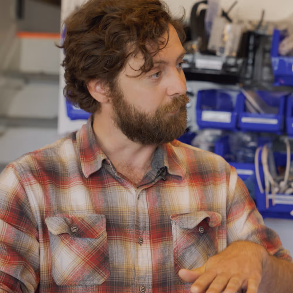 A male CEO explaining his product at his workshop.