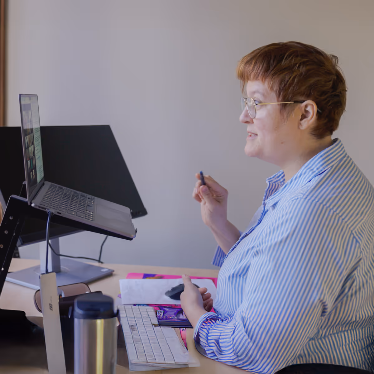 Danielle at her desk presenting during a video conference.