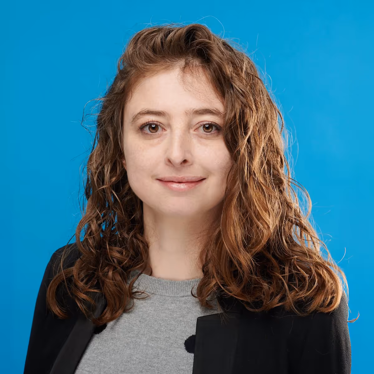 A portrait of Tina Boville on a blue background.