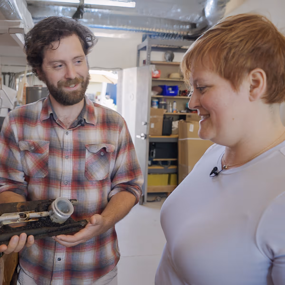 Danielle meeting with a client in their workshop as he excitedly shows her around.