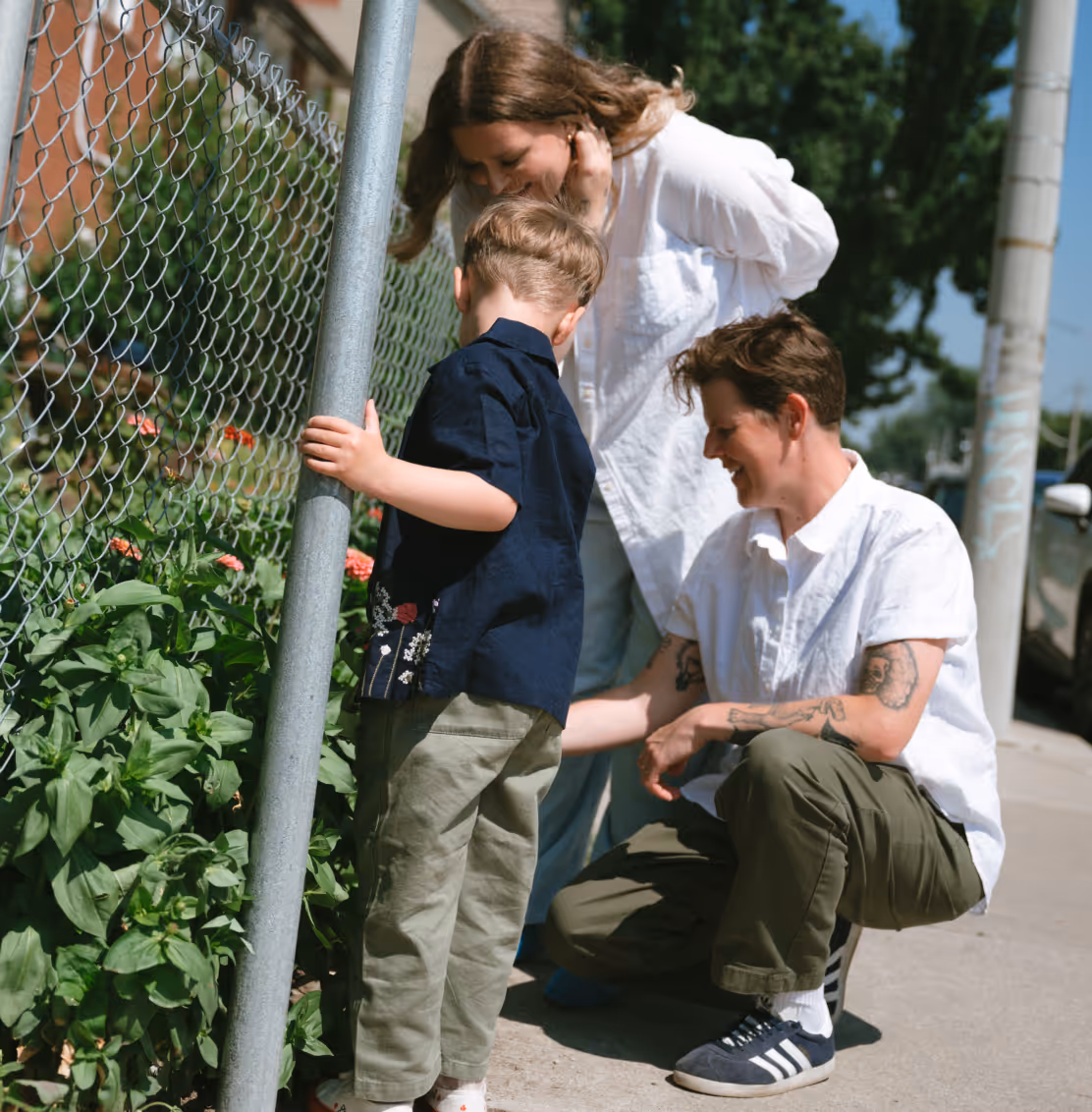 a group of people standing next to a fence