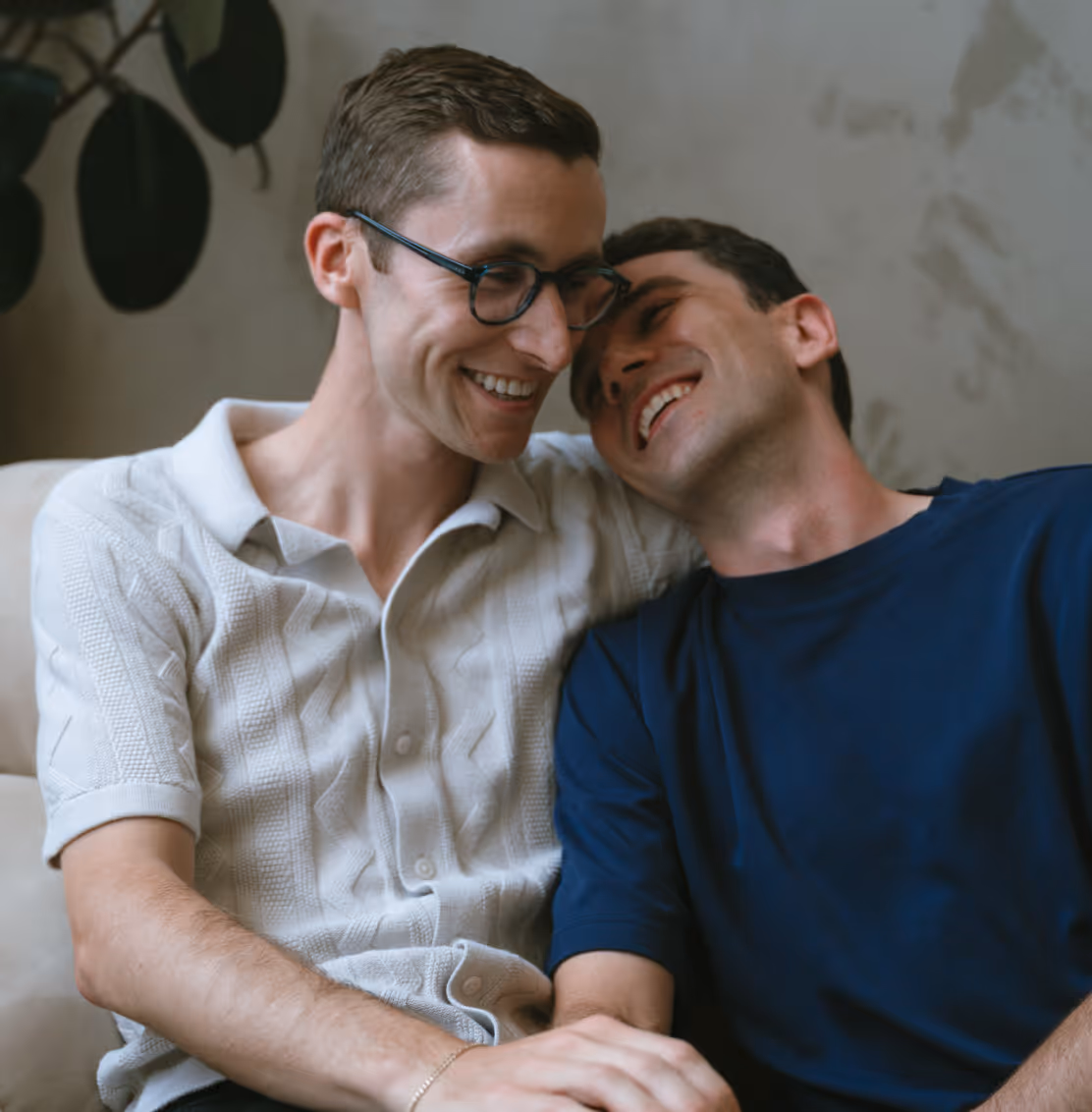 two men sitting on a couch