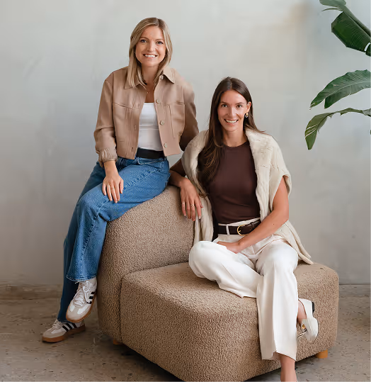two women sitting on a couch