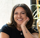 a woman smiling with her hand on her chin