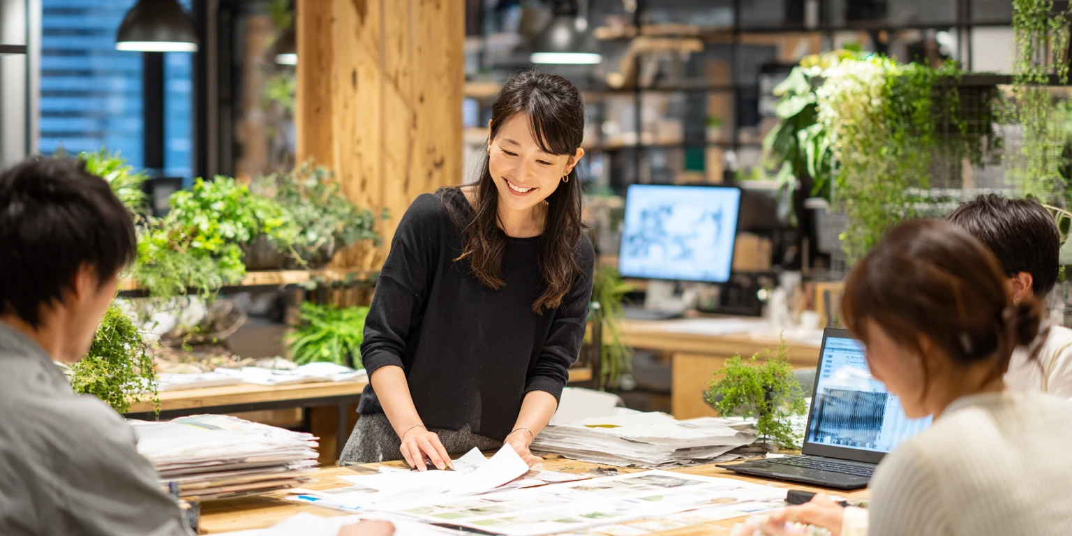 A creative studio team collaborating on a website redesign strategy and UI/UX wireframes to improve client conversion rates.