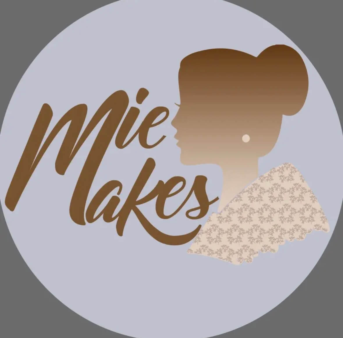 Logo with silhouette of a woman in profile wearing a patterned shawl next to the stylized text 'mie Makes'.