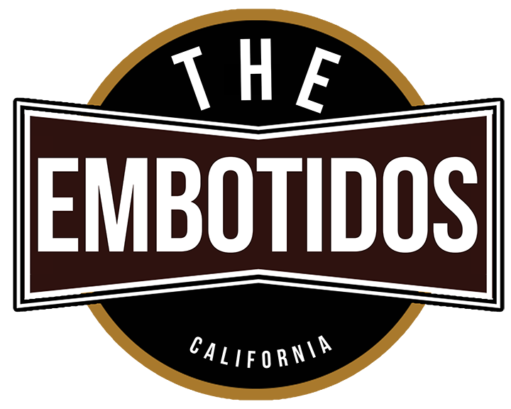 Logo for The Embotidos California featuring bold white text on a brown and black background with a gold circular accent.