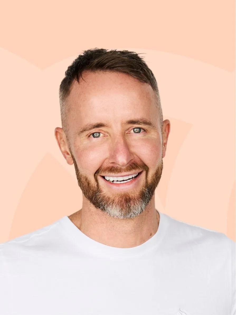 A man with a goatee smiles at the camera.