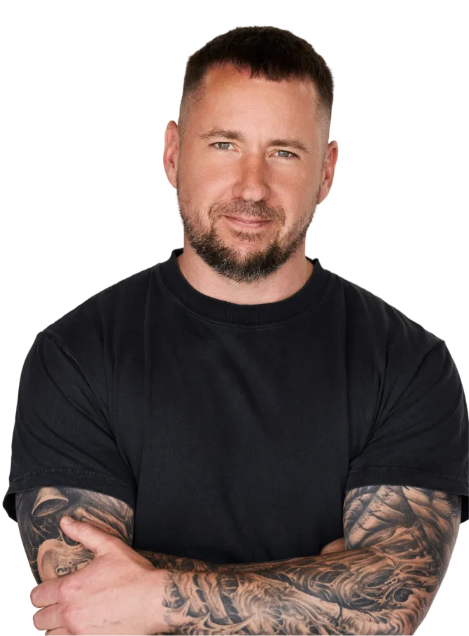 A man with tattoos and a black shirt.