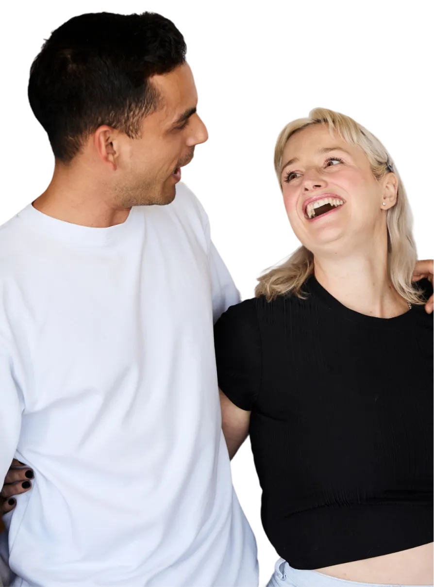 A man and a woman laughing together.