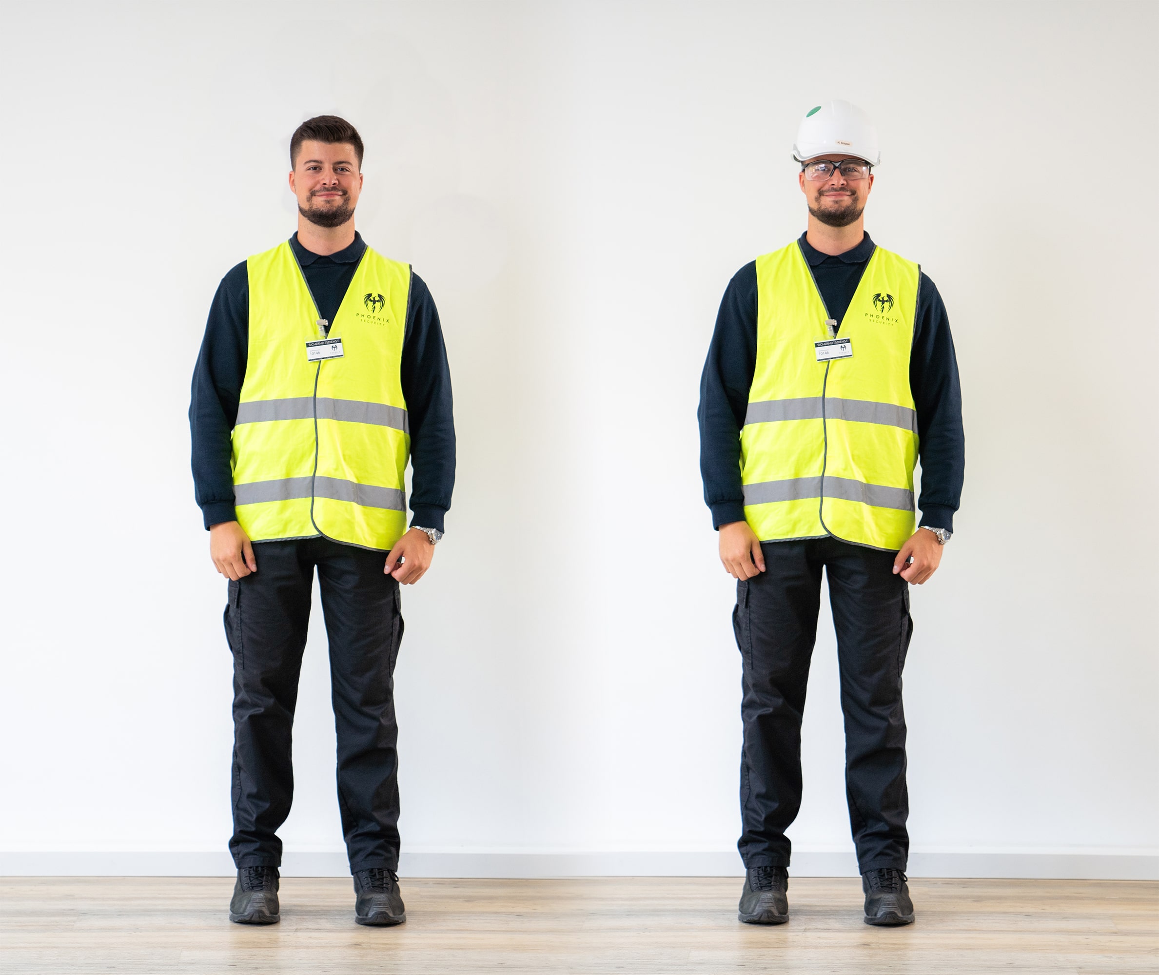 Zwei Männer in gelben Sicherheitswesten und dunkler Kleidung, einer trägt einen weißen Schutzhelm und eine Schutzbrille.