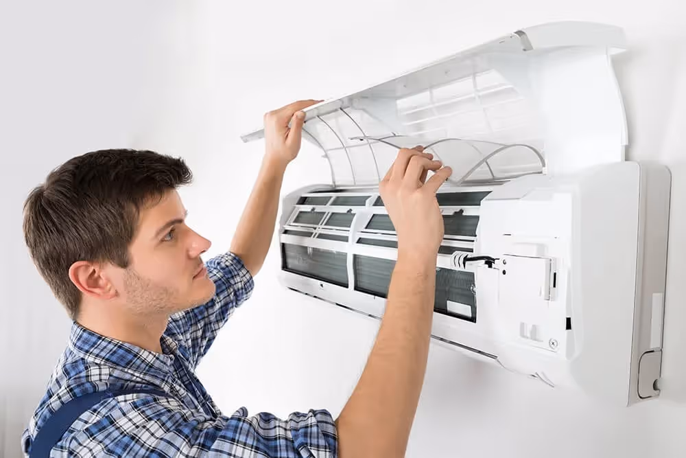 Man cleaning split AC indoor unit.