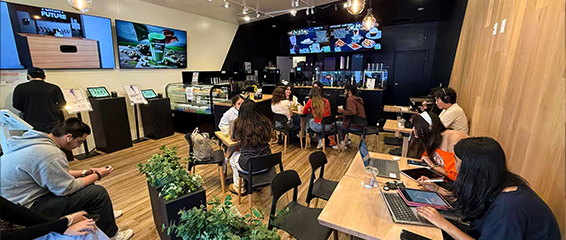 A group of people sitting at tables in a room.