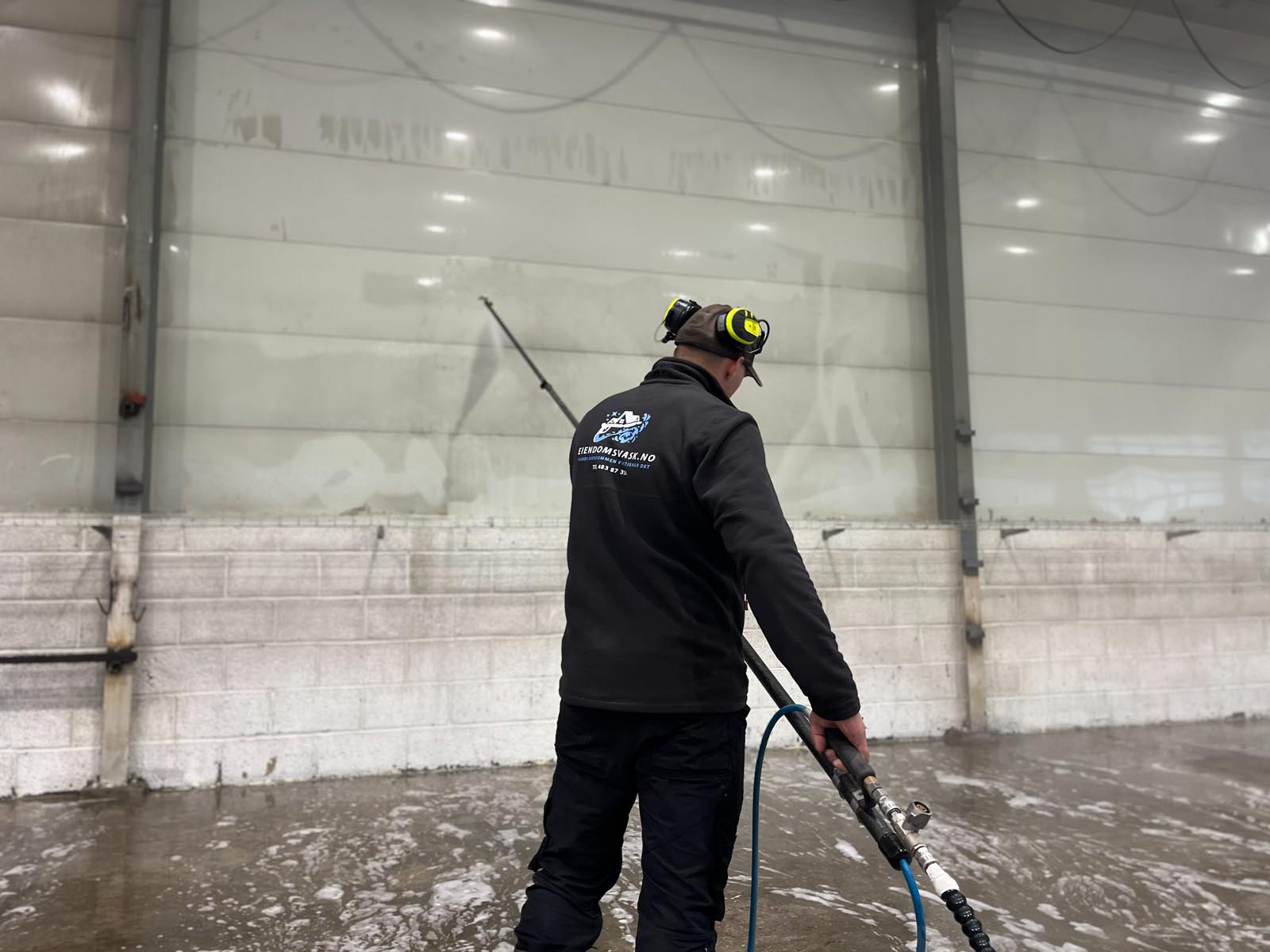 Ansat i eiendomsvask som utfører en verkstedvask