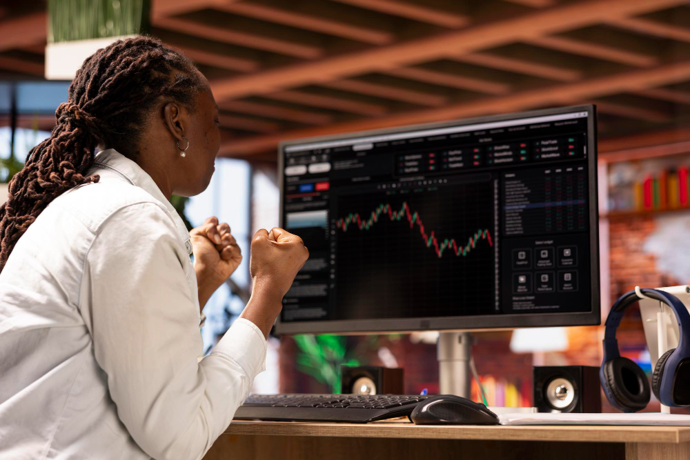 woman sitting infront of a desktop - Fair Value Gap Trading