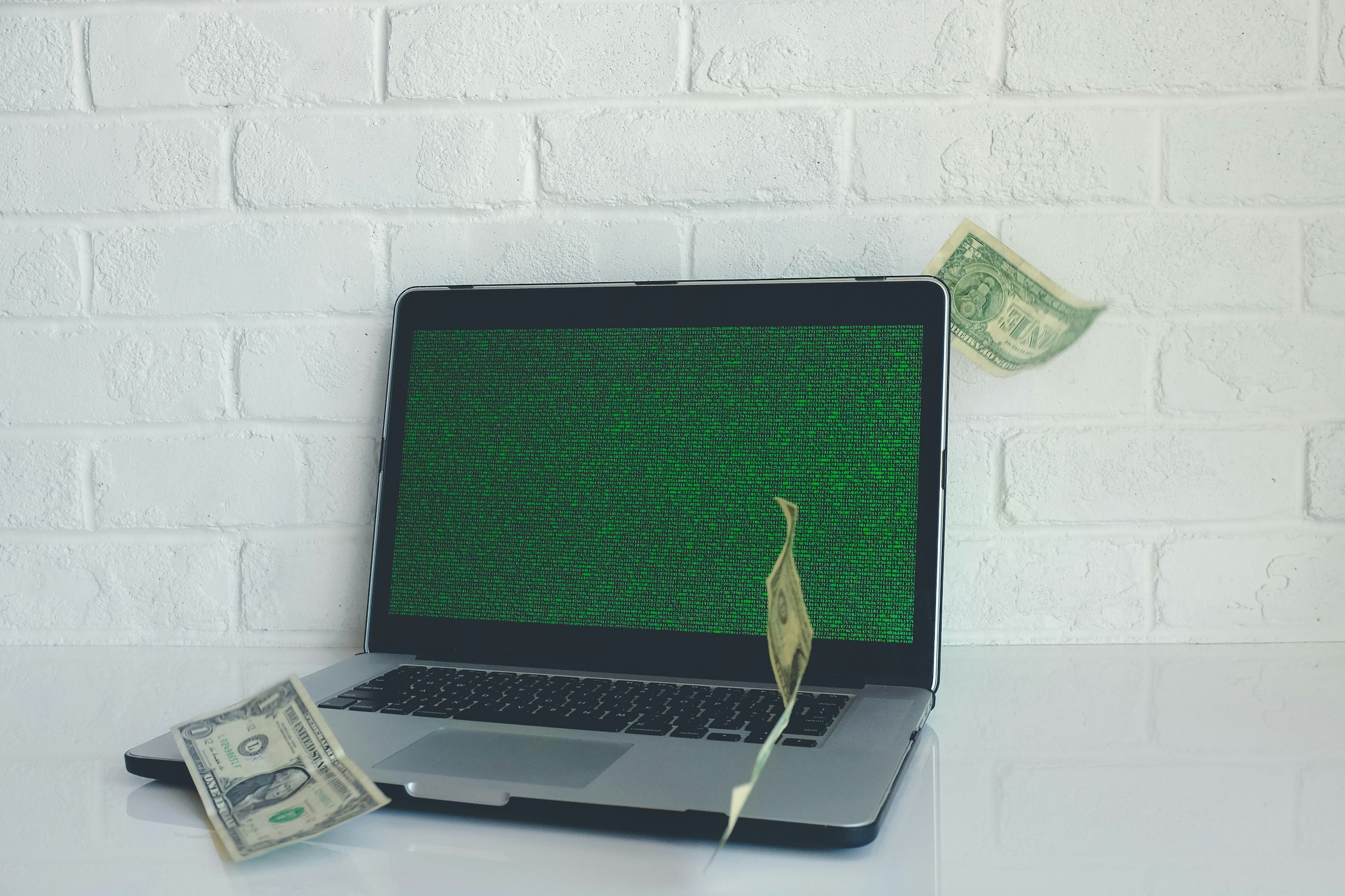 Money Landing on Laptop - How To Get Funded For Trading