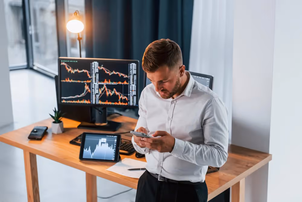 man using a phone - Margin vs Leverage