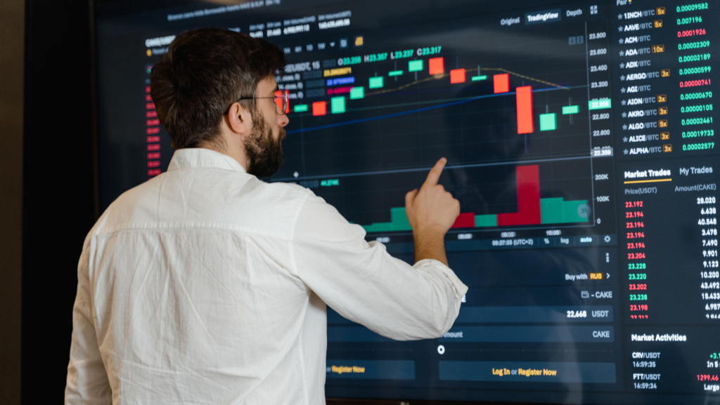 man looking at a candle stick chart - Support and Resistance in Trading
