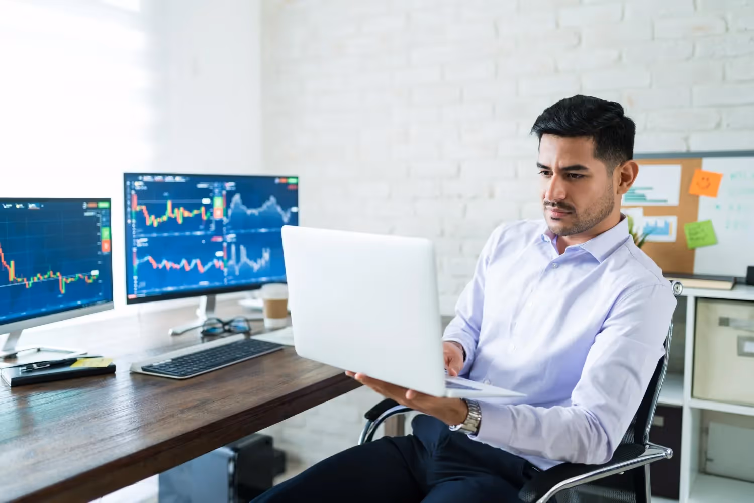 man using a laptop - NFP Trading